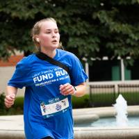 Participant nearing finish line passing by fountain